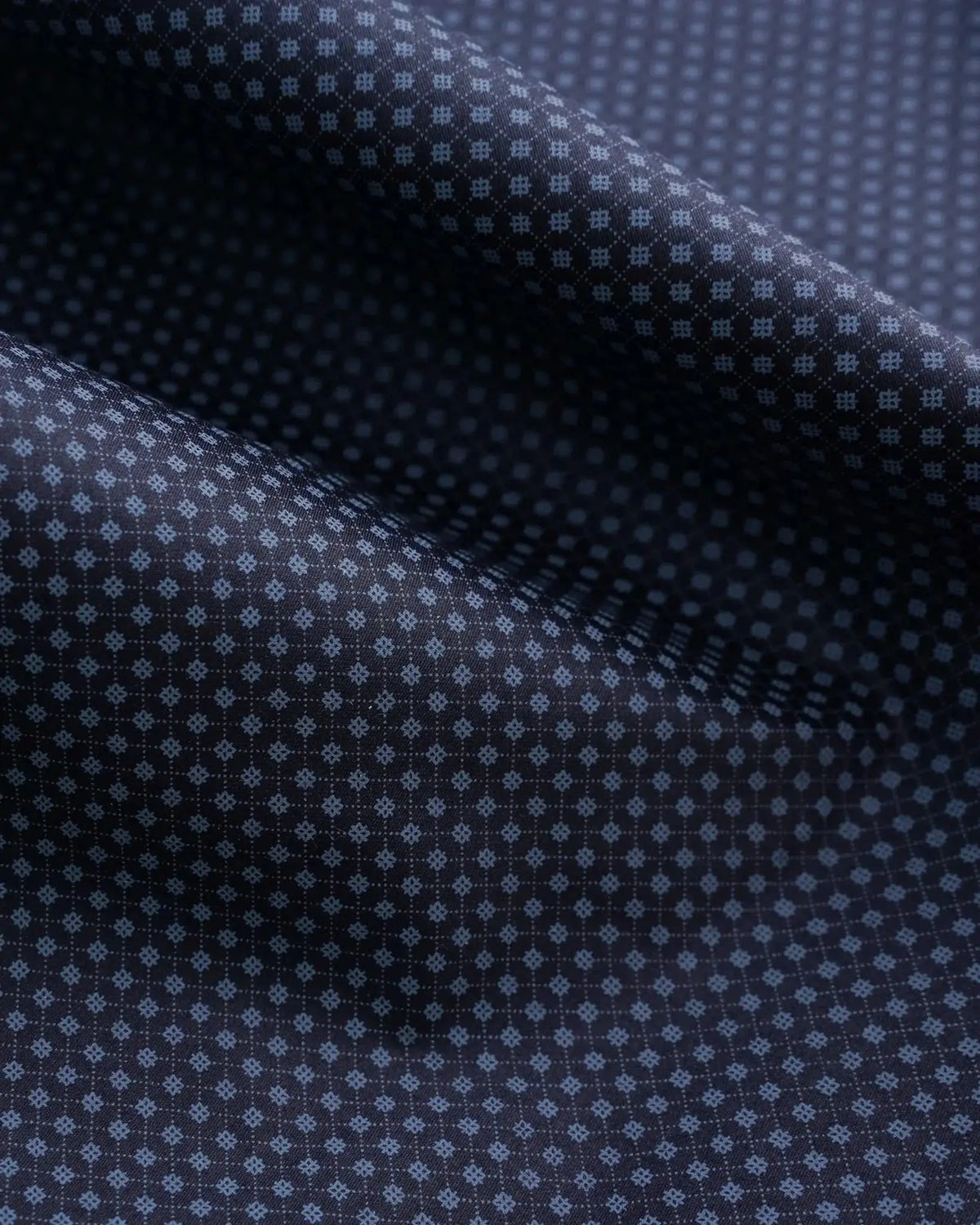 Close-up of dark blue fabric with a subtle pattern