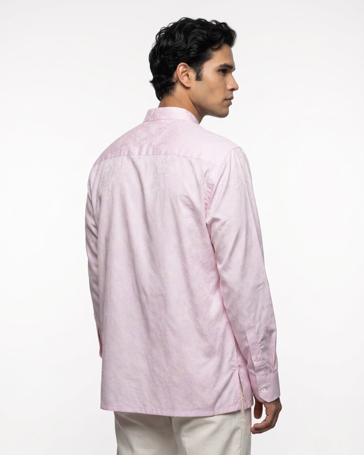 A man wearing a light pink floral jacquard long-sleeve kurta, shown from the back and side profile against a plain white studio background.
