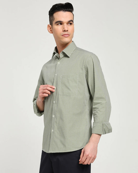Man wearing a green checkered shirt against a plain background